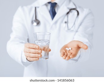 Picture Of Doctor Hands Giving White Pills And Glass Of Water