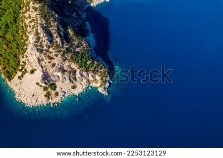 A picture from a drone top view of a amazing rock in the azure Mediterranean Sea. Beautiful travel background. High quality photo