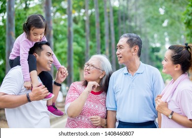 Picture Of Extended Family Talking Each Other After Doing Exercise Together In The Park