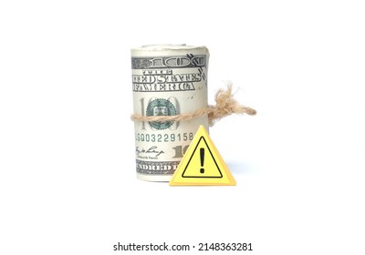 A Picture Of Fake Money With Warning Sign On White Background. Financial Crime Concept.