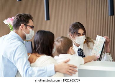 Picture Of Family Checking In Hotel