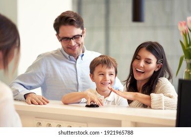 Picture Of Family Checking In Hotel