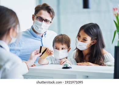 Picture Of Family Checking In Hotel