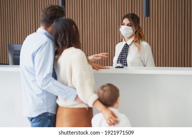 Picture Of Family Checking In Hotel