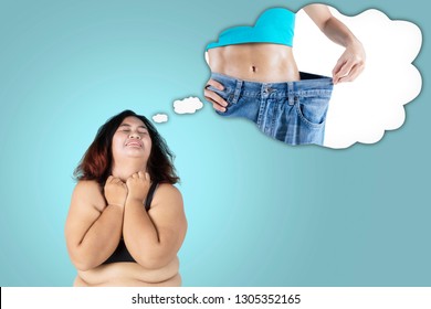 Picture of fat woman looks sad while imagining her dream to get slim body