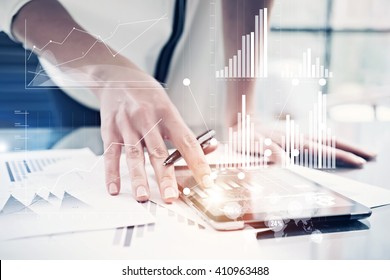 Picture female hand touching modern tablet.Investment manager working new private banking project office.Using electronic device.Graphic icons,worldwide stock exchanges interface on screen. Horizontal