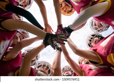 Picture of female rugby players stacking their hands together - Powered by Shutterstock