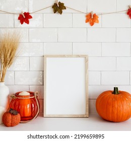 Picture Frame Mockup With Orange Pumpkins, Vase Of Wheat, Garland Of Leaves On Wall Tile Background. Cozy Home Interior With Autumn Fall Decor.