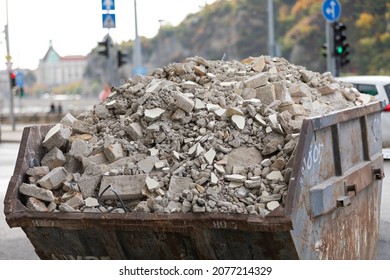 Picture of a fully loaded dumpster with construction materials