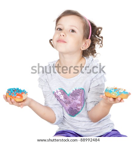 Picture of funny little girl with colorful donuts on white background