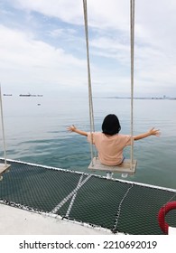 The Picture Of A Girl Sitting On A Swing Looking At The Sea Alone Alone