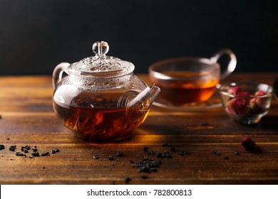 Picture Of Glass Teapot With Cup Of Black Tea And Golden Tray On Wooden Table. Overhead View, Copy Space.