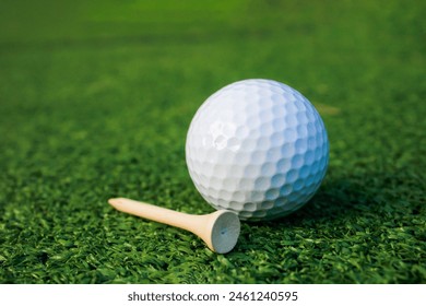 A picture of a golf ball lying on the grass next to the tee, not ready for playing. - Powered by Shutterstock