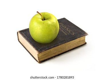 Picture. Green Apple Lies On The Physics Book Of Isaac Newton On A White Background