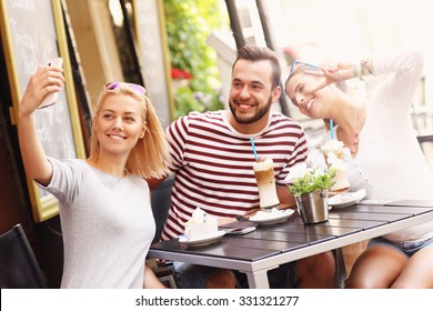 A picture of a group of friends taking picture in the restaurant