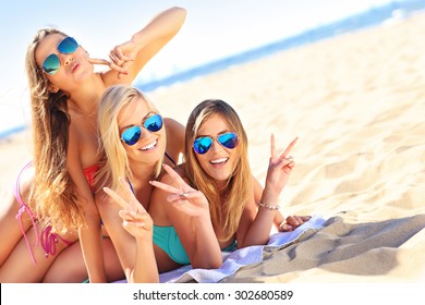 A Picture Of A Group Of Women Having Fun On The Beach