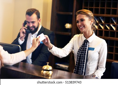 Picture of guests getting key card in hotel - Shutterstock ID 513839743