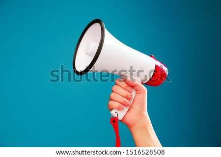 Picture of hand with mouthpiece on empty blue background
