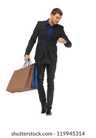 Picture Of Handsome Man In Suit With Shopping Bags.