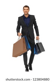 Picture Of Handsome Man In Suit With Shopping Bags.