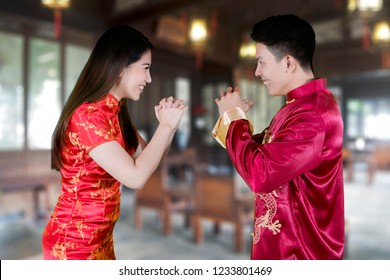 Picture Of Happy Chinese Couple Congratulating Each Other While Standing At Home