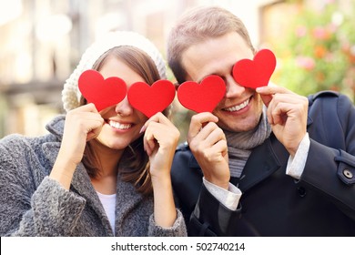 Picture Of Happy Couple Covering Eyes With Hearts