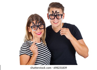 Picture Of A Happy Couple Posing With Photobooth Accesories On Isolated Background