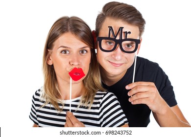 Picture Of A Happy Couple Posing With Photobooth Accesories On Isolated Background