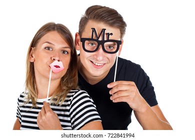 Picture Of A Happy Couple Posing With Photobooth Accesories On Isolated Background