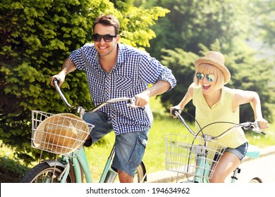 A picture of a happy couple spending free time on bikes in the city