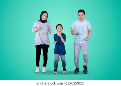 Picture Of Happy Muslim Family Looking At The Camera While Jogging Together In The Studio