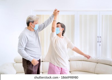 Picture Of Happy Senior Couple Wearing Face Mask While Dancing Together During Quarantine At Home
