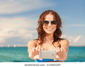 Picture Of Happy Smiling Woman Using Phone Camera .