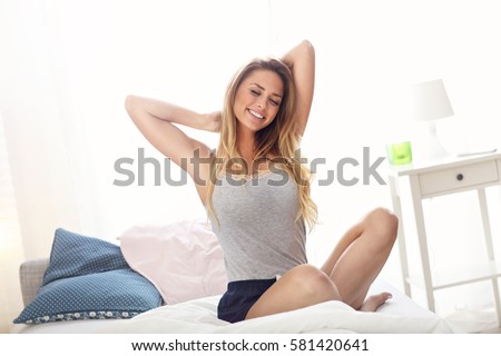 Picture of happy woman stretching in the morning