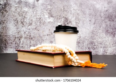 A Picture Of Holy Quran With Tasbeeh And Empty Paper Cup On Isolated Crack Wall Background For 