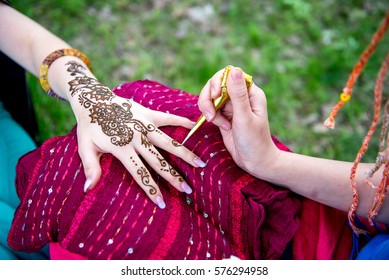 Picture of human hand being decorated with henna Tattoo. mehendi hand - Shutterstock ID 576294958