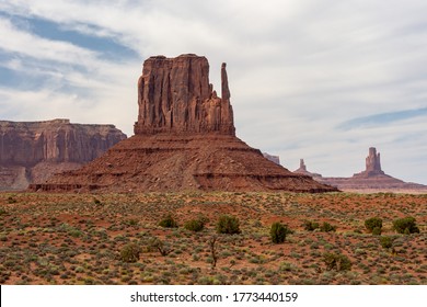 Picture Of Iconic West Butte Rock Formation In Oljato-Monument Valley Taken On A Summer Cloudy Day From The Unpaved, Sandy, Scenic Drive. Other Buttes Are Visible In Far Distance.