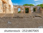 Picture of the interior of a ruined room, from a window, in the ruins of the former Carabinier Barracks of the Spain