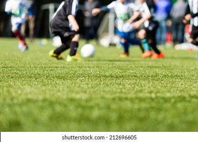 Picture of kids soccer training match with shallow depth of field. Focus on foreground.