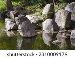 picture of large rocks at a pond of a landscaped Japanese garden