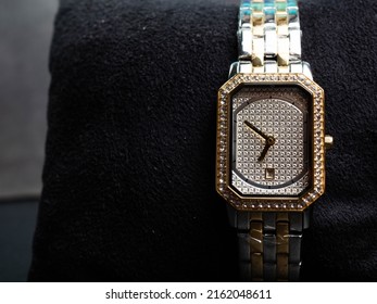 Picture of luxury woman wrist watch. Thus watch on a gold color and silver dial