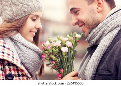 A Picture Of A Man Giving Flowers To His Lover On A Winter Day