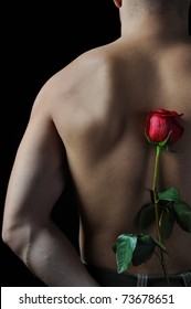 Picture A Man  Holding A Red Rose Behind His Back. Isolated On White Background