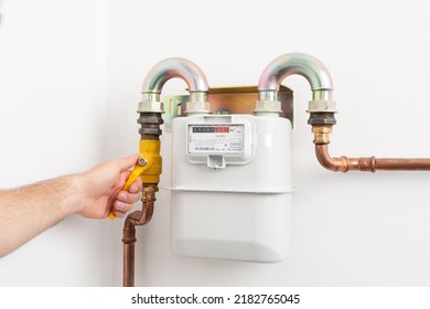 Picture of man opening the gas valve. Gas meter in private house. High costs of gas. - Shutterstock ID 2182765045