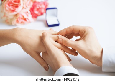 Picture Of Man Putting  Wedding Ring On Woman Hand