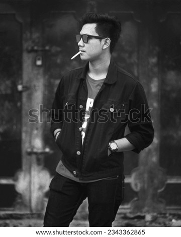 Similar – young guy in a shirt smokes on the street