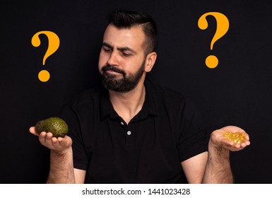 A Picture Of A Man Surrounded By Question Marks, Trying To Decide Either To Eat Healthy, Natural Foods Or Take Supplements Instead.