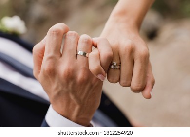 Picture of man and woman with wedding ring.Young married couple holding hands, ceremony wedding day. Newly wed couple's hands with wedding rings. 