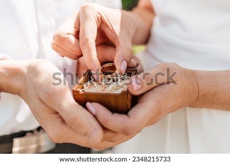 Picture of man and woman with wedding ring.Young married couple holding hands, ceremony wedding day. Newly wed couple's hands with wedding rings. [[stock_photo]] © 