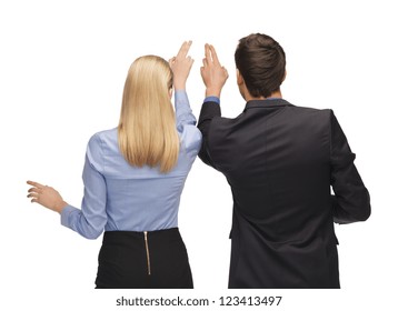 picture of man and woman working with something imaginary.